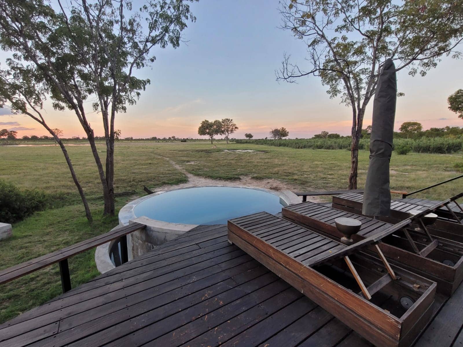 View of the pool and the pool deck at Little Makalolo, overlooking Hwange National Park