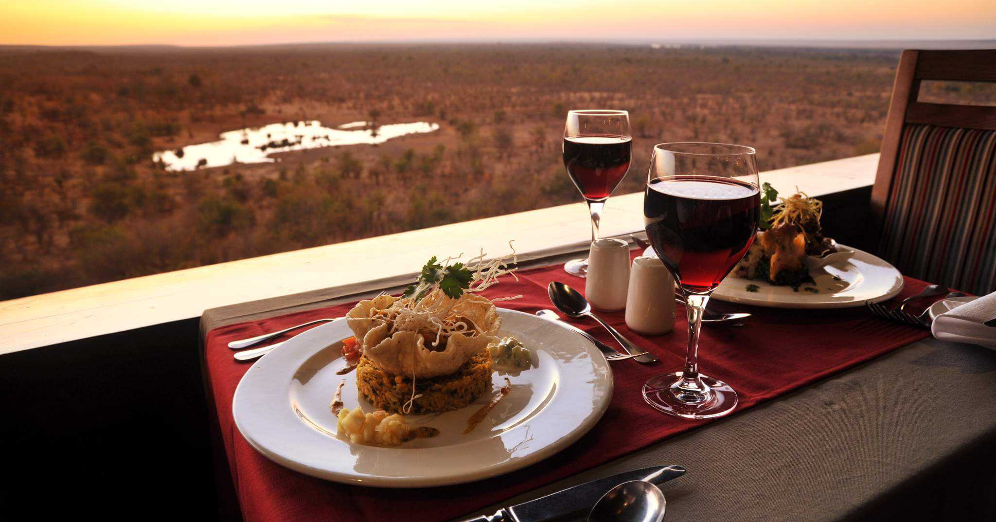 A view over the waterhole while dining at the Victoria Falls Safari Lodge