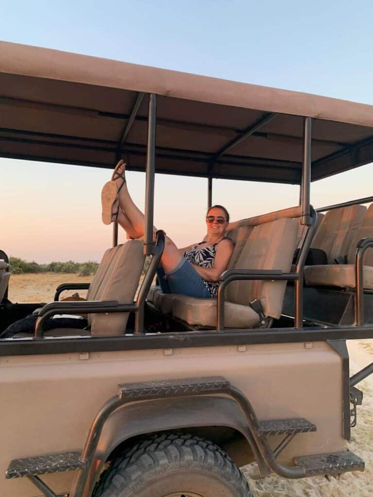 Sam from The Safari Addict sitting in a safari land cruiser in Botswana