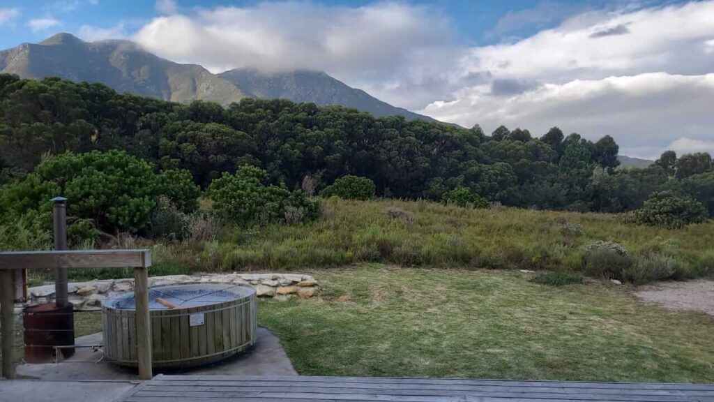 View of the mountains with the wood-fired hot tub in front of the tent