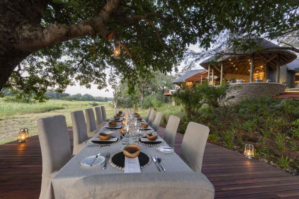 Dining table under the trees at Dulini River Lodge in the Sabi Sands