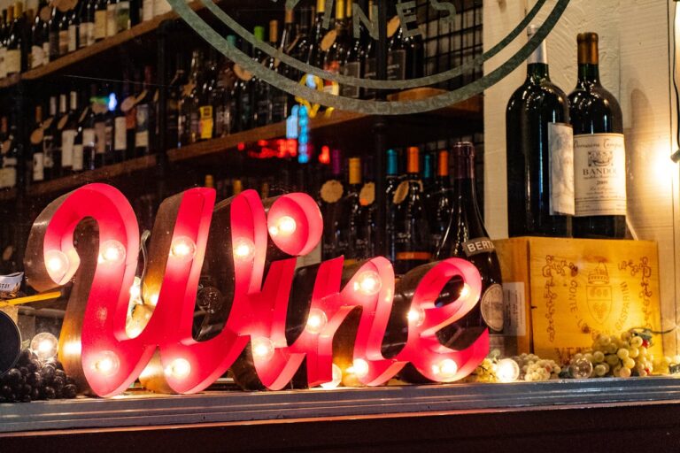 Wine tasting with a neon light that says 'wine'