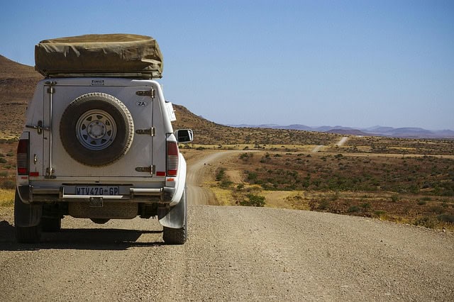 4x4 vehicle driving on an open road in Africa