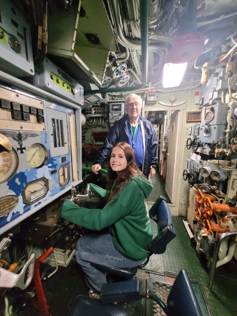 Nikita inside the submarine in the steering seat
